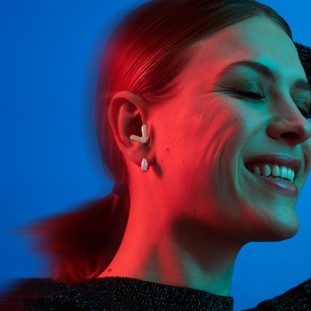 Woman wears Alpine Tune in rose-gold showcases advanced music filter USP