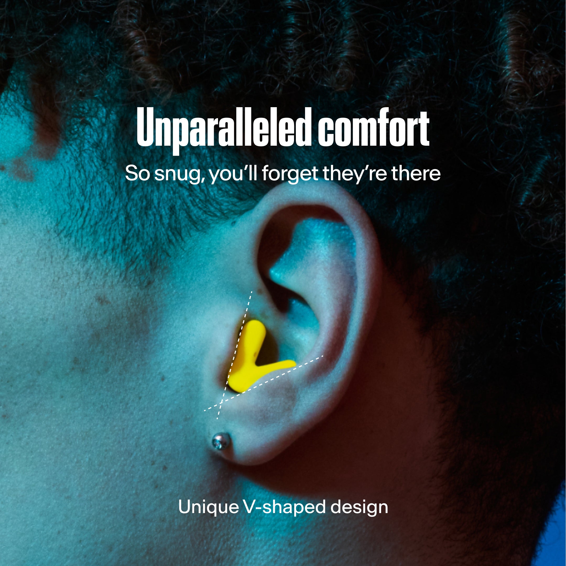 Detailed image of an ear with an Alpine Tune earplug in neon yellow showing the snug fit in ear
