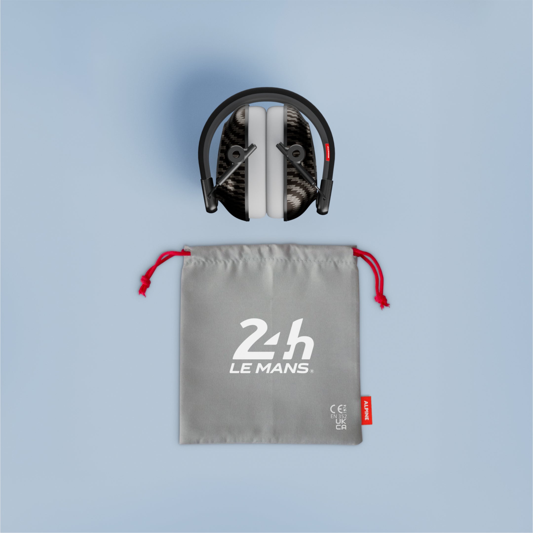 Folded Alpine 24h Le Mans Muffy earmuffs above a grey drawstring pouch with red cords and 24h Le Mans logo 