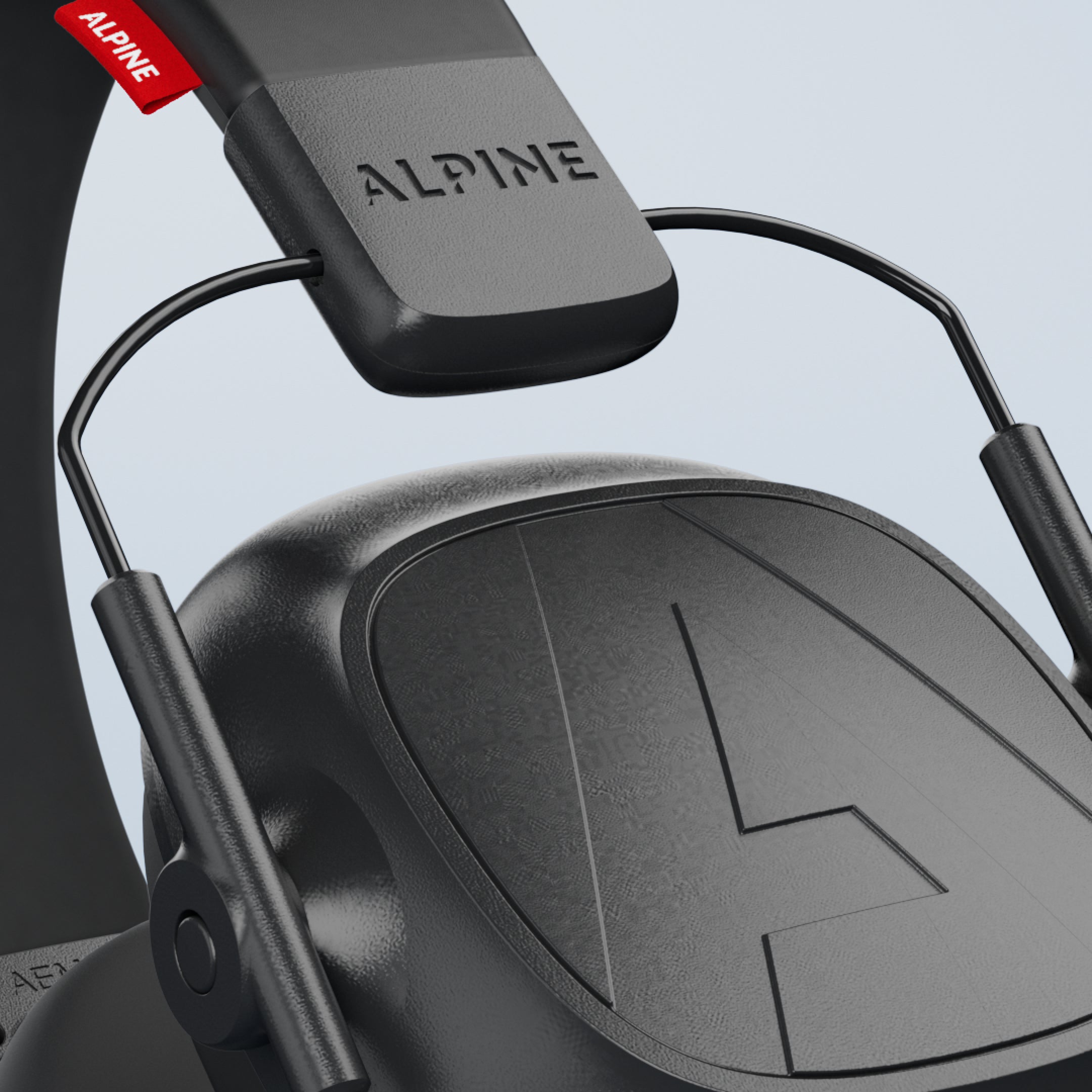 Close-up of the Alpine Defender headband and ear cup with Alpine logo