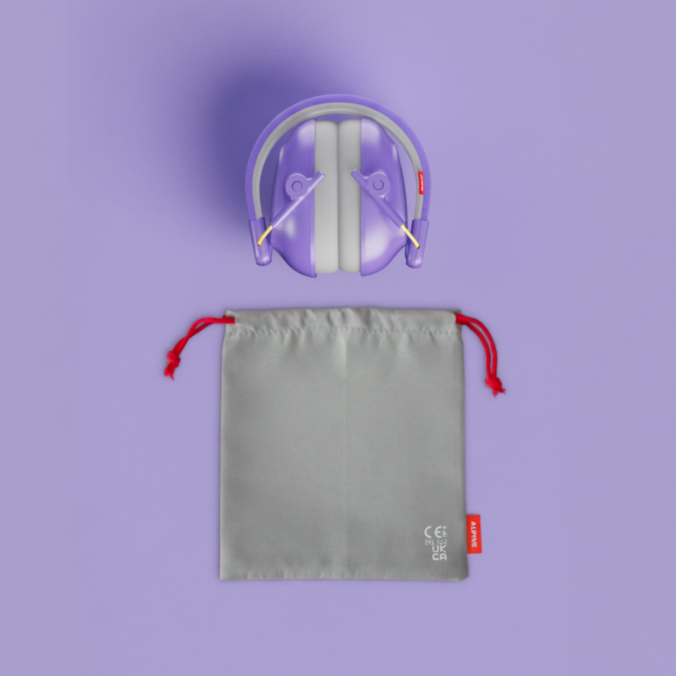 Alpine Muffy Baby ear defenders in purple, folded, with grey carrying pouch 